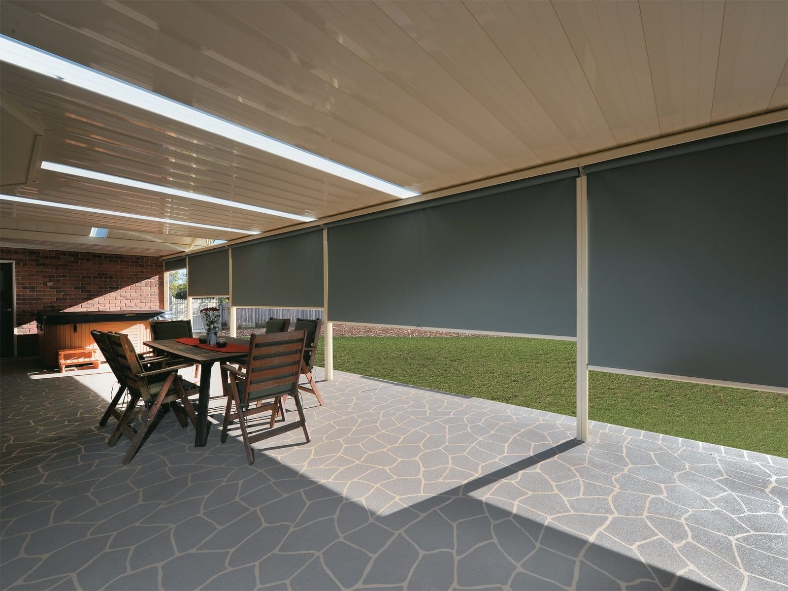 Patio with lights at night set up under retractable roof by Undercover Blinds and Awnings in Melbourne
